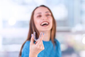 Beautiful,Smiling,Turkish,Woman,Is,Holding,An,Invisalign,Bracer,,Includes