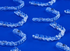 several clear aligner trays in a flat surface several clear aligner trays in a flat surface