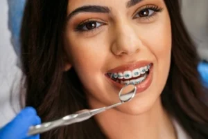smiling woman with braces undergoing dental check up smiling woman with braces undergoing dental check up
