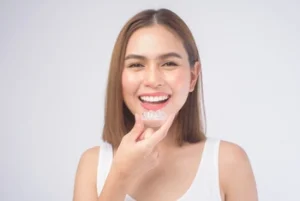 woman showing how one should wear invisalign aligners woman showing how one should wear invisalign aligners
